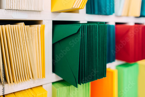 Quadro su tela Various sort mail envelopes arranged on a shelf by color and type categories