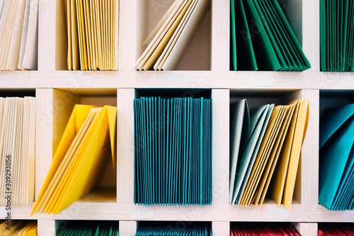 Photos Multicolored mail envelopes arranged on a shelf by color and type categories