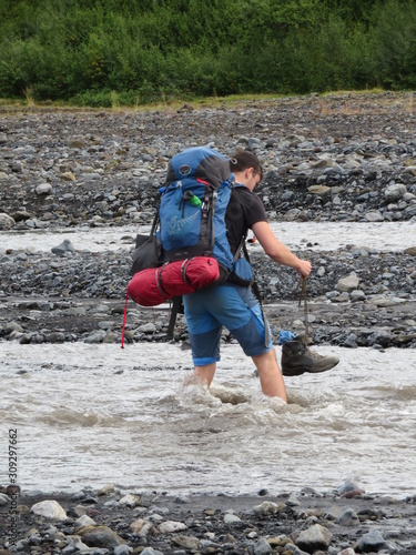 hiker on river crossing