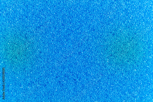 Blue sponge made of microfiber material. Texture, background. In Increase