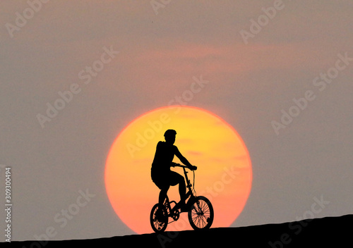 Silhouette  Cycling  on blurry sunrise  sky   background.