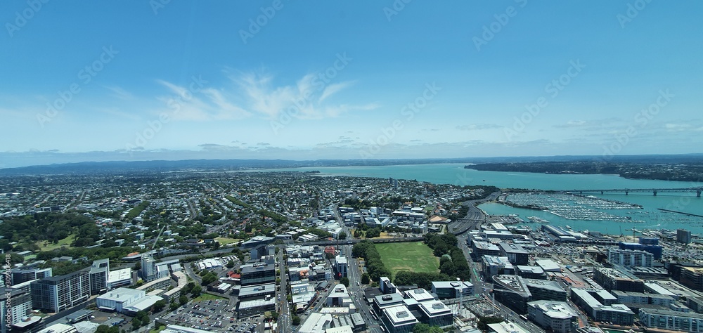 Viaduct Harbour, Auckland / New Zealand - December 13, 2019: The timelapse and general skyline of Auckland city, seen from the top of the landmark Sky Tower
