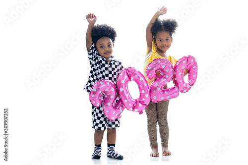 Happy African boy and girl, dark skinned kids with numbers balloon 2020 on white background, happy new year 2020, with clipping path