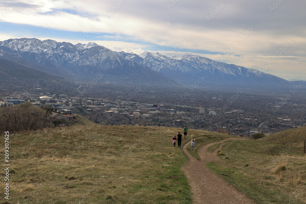 Family on a stroll in the foothills of the Wasatch enjoying views of downtown Salt Lake City
