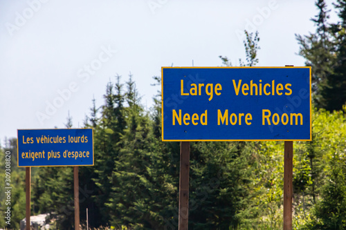 French and English two Information road Signs, large vehicles need more space. on the Canadian rural country roadside, Ontario, Canada photo
