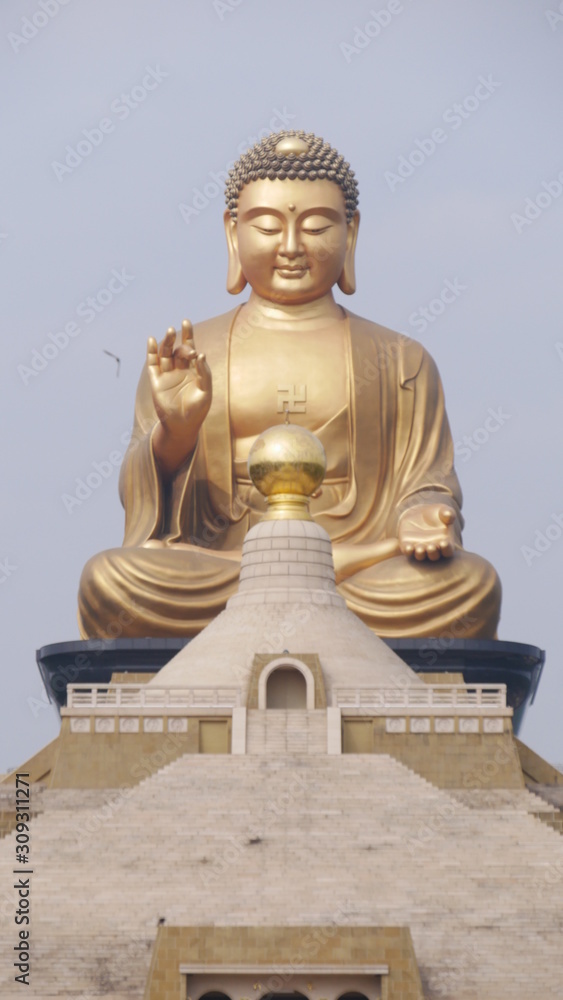 Fototapeta premium Fo Guang Shan Chinese temple and a big golden Buddha statue and Pagoda in Kaohsiung, Taiwan.
