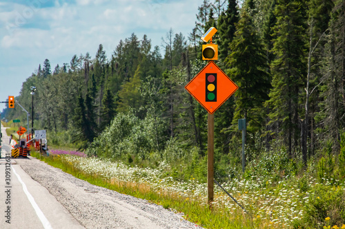Vászonkép Temporary condition road warning signs on the roadside before road work zone, signal traffic lights ahead