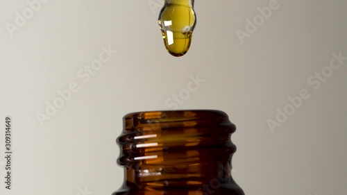 Gold oil in retro rustic brown glass bottle dripping medication tincture homeopathy photo