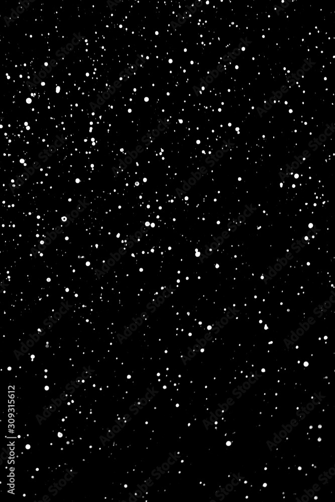 Chaotic white star bokeh on a isolated black background. falling blurry bokeh snow overlay, starry sky. white spots on black background, white drops and spots. abstraction.