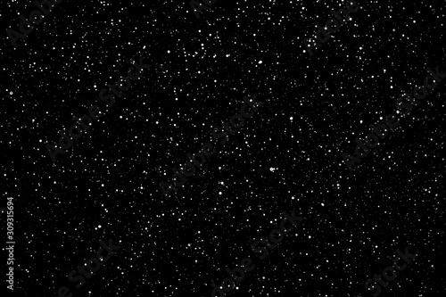 Chaotic white star bokeh on a isolated black background. falling blurry bokeh snow overlay, starry sky. white spots on black background, white drops and spots. abstraction.