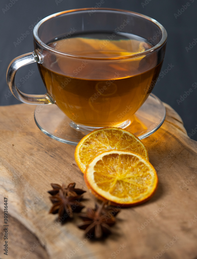 A warm cup of tea with orange and anise ,herbal tee A warm cup of tea with orange and anise ,herbal tee
