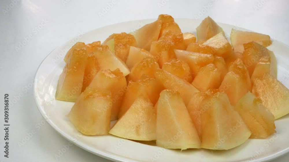 Exotic melon fruit close-up. Sliced melon on a white background Exotic melon fruit close-up. Sliced melon on a white background
