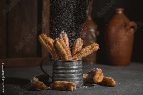 Bild auf Leinwand Traditional churros sticks with cinnamon and sugar powder