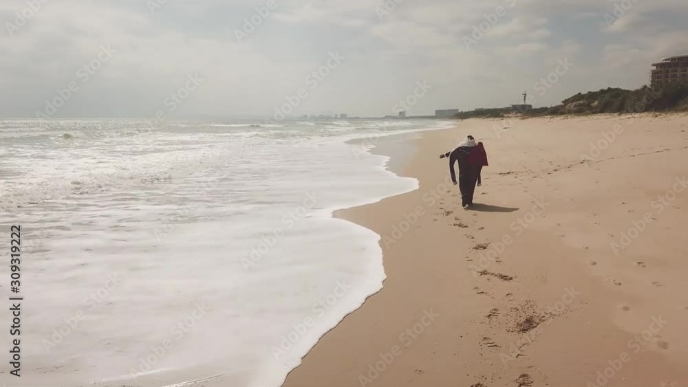 Russian Santa Claus with a bag of gifts walks along the seashore. Russian Santa Claus with a bag of gifts walks along the seashore.