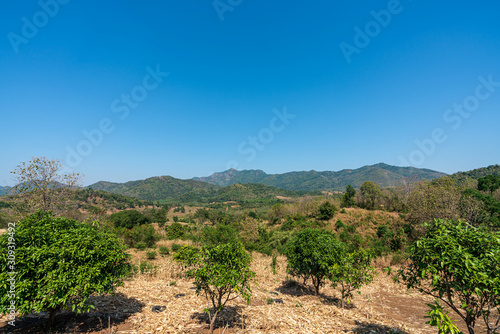 beautiful blue sky high peak mountains mist fog wildlife green forest at Phu Khao Hin Pakarang,  Khao Koh, Phetchabun, Thailand. guiding idea long weekend for backpacker camping hiking   © Tony