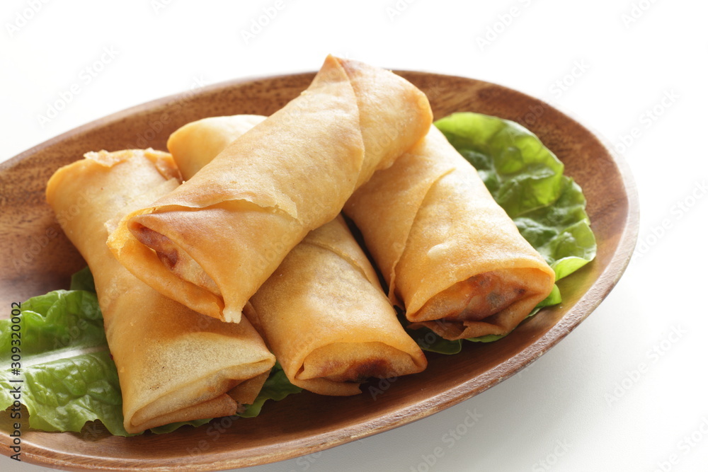 Chinese food, spring roll on wooden plate Chinese food, spring roll on wooden plate