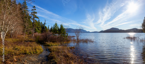 Panoramic View of Kennedy Lake surrounded by Canadian Mountains during a vibrant sunny day. Located near Tofino, Vancouver Island, British Columbia, Canada.