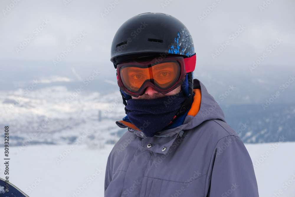 Young snowboarder in the mountains on top. Active rest on a snowboard. Young snowboarder in the mountains on top. Active rest on a snowboard.