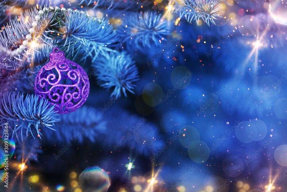 Fototapeta premium Christmas and New Year holidays background. Glitter lights backdrop. Winter season. Text space. Closeup of Christmas-tree.