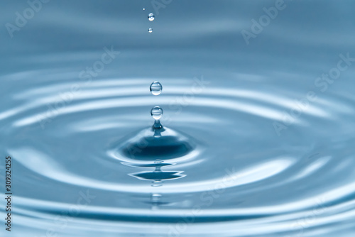 Beautiful splash of water drop on water surface, macro photo