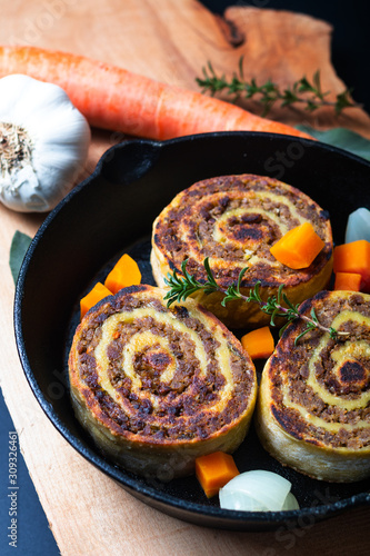 Food concept Fleischschnackas  Alsatian, Alsace French local food meat stuffed in egg roll pasta in skillet iron pan photo