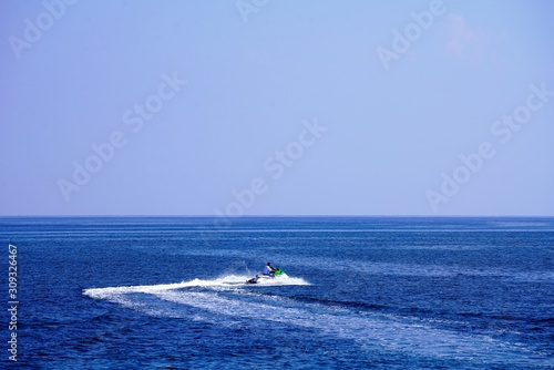 speeding jet ski in the deep blue azure sea