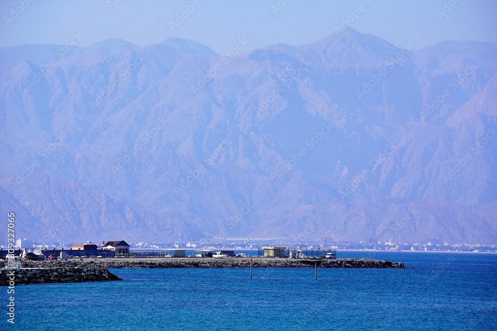 boats in the bay by peaks of Hajar mountains