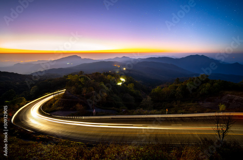 Landscape Doi Inthanon National park before the sunrise and light trail from cars at Chiang Mai Province, Thailand