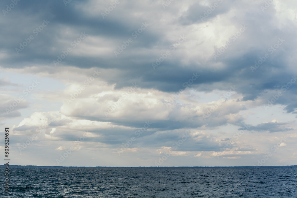 Beautiful white clouds over water surface of wide river Beautiful white clouds over water surface of wide river