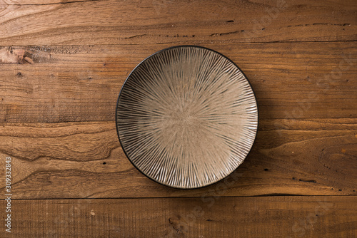Plate on brown wooden background