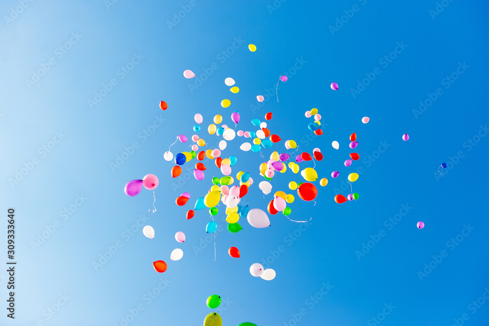 inflatable balloons in the sky released into the sky at graduation in school kindergarten. Multicolored inflatable balloons with helium flying in the sky