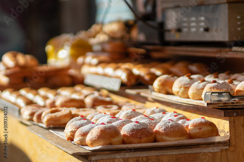 Hanukkah donuts (sufgania) are delicious and sweet in honor of Chanukah (the winter Jewish holiday in memory of miracles and wonders). Filled with strawberry jam or milk jam and deep-fried. photo