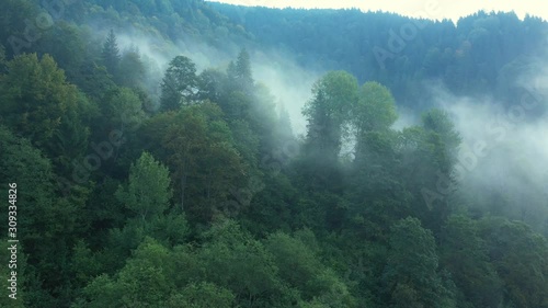 Flying through the clouds above mountain tops. High peaks wonderful morning sunrise natural Landscape