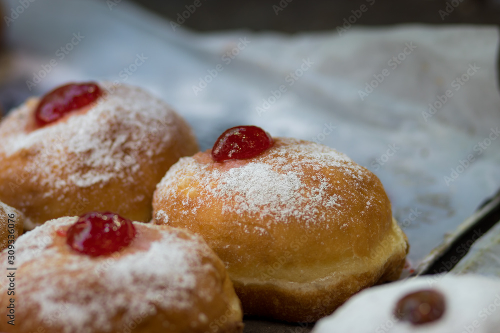 Hanukkah donuts (sufgania) are delicious and sweet in honor of Chanukah (the winter Jewish holiday in memory of miracles and wonders). Filled with strawberry jam or milk jam and deep-fried.