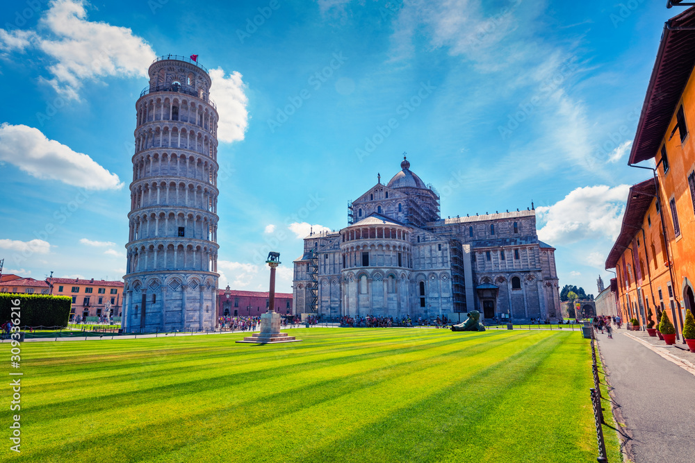 Colorful summer view of famous Leaning Tower. Superb morning scene with hundreds of tourists in Piazza dei Miracoli (Square of Miracles), Pisa, Italy, Europe. Traveling concept background.