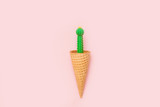 Green cactus in a waffle cup isolated on pink background