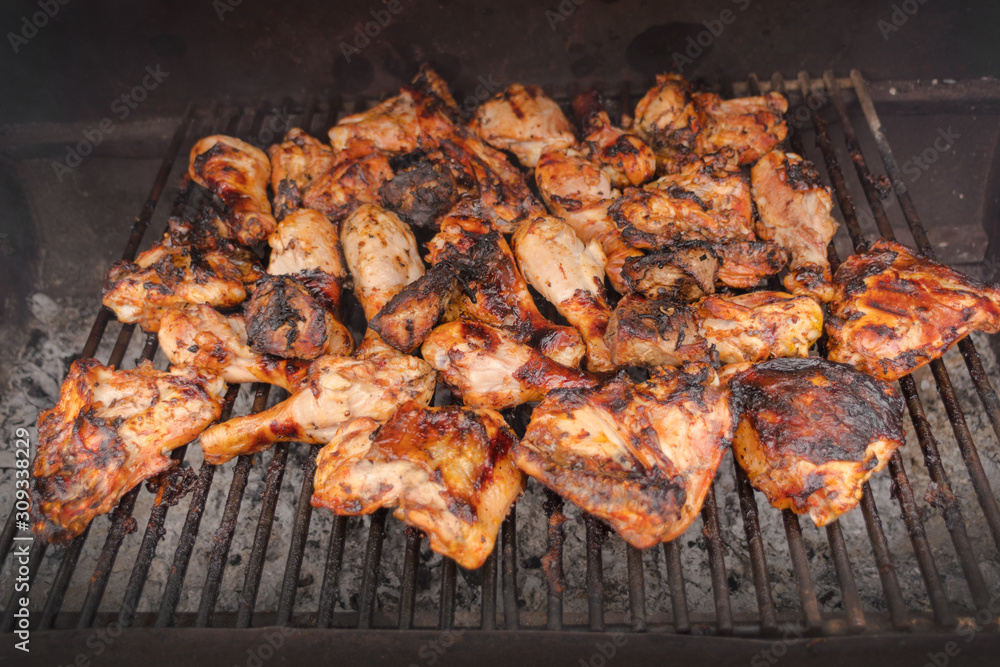 Grilling chicken wings and legs. BBQ, picnic, relaxation