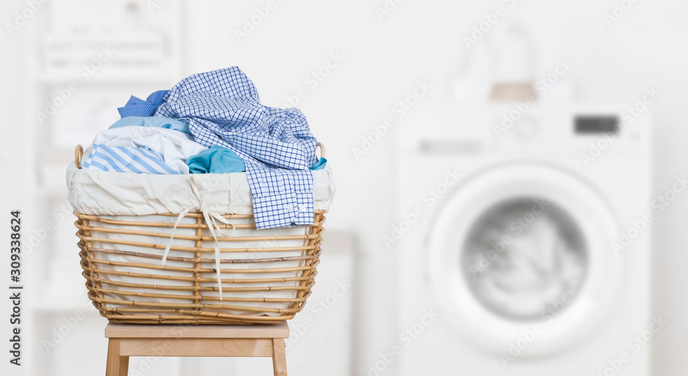 Laundry basket on blurred background of modern washing machine - obrazy, fototapety, plakaty 