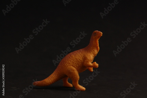 plastic toy with dinosaur shape in color background