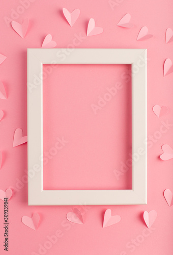 pink pastel background with white frame and hearts © Elena