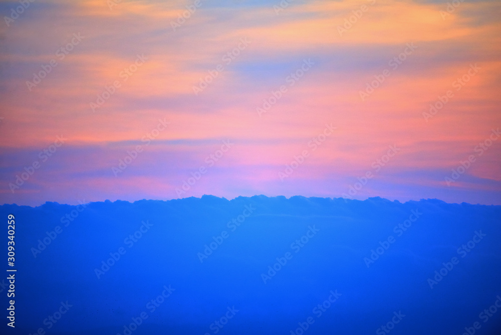 Spectatcular colorful sunset. Vivid blue colored clouds on the evening sky.