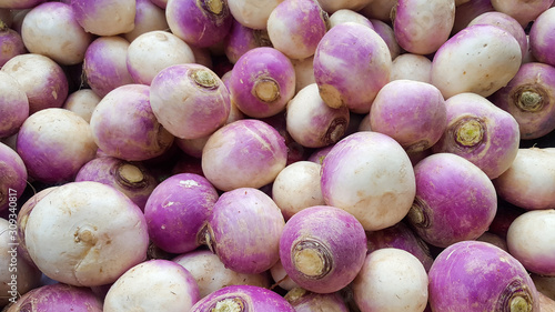 Fresh, organic turnips, brassica rapa subsp, on display at a farmer's market stall in the UK