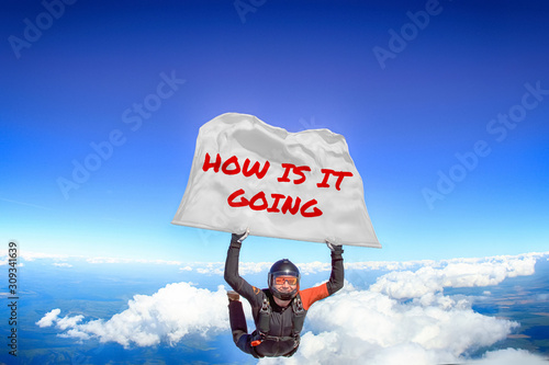 How is it going. Flag in skydiving. People in free fall.Teampleat skydiver. Extreme sport.