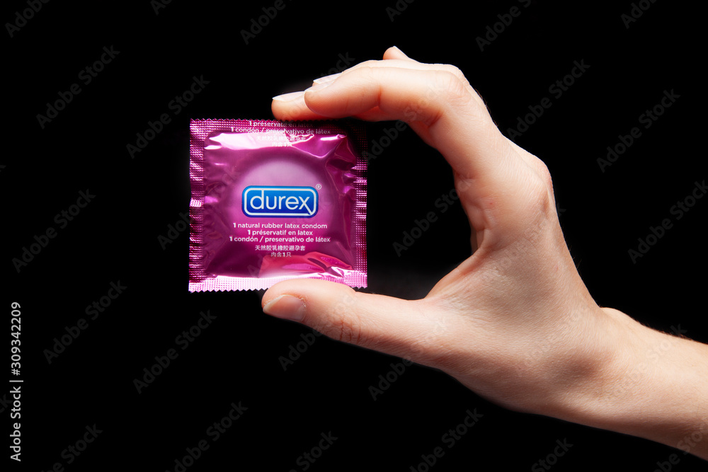 Moscow / Russia - 06 Mar . 2016: condom Durex in hand girl on black  background Stock Photo | Adobe Stock