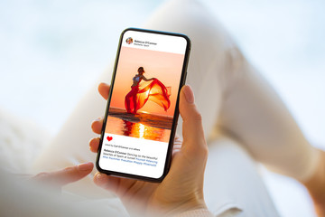 Woman looking at photo on social media app, person names on screen are all made up