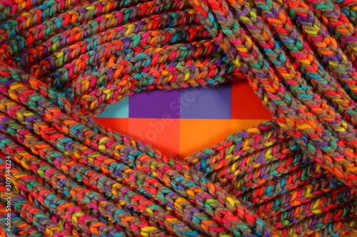 pattern fabric wool Background. relax autumn and winter season arrangement flat lay style with copy space. knitting wool scarf from multi-colored woolen threads. multicolored woolen soft texture. 