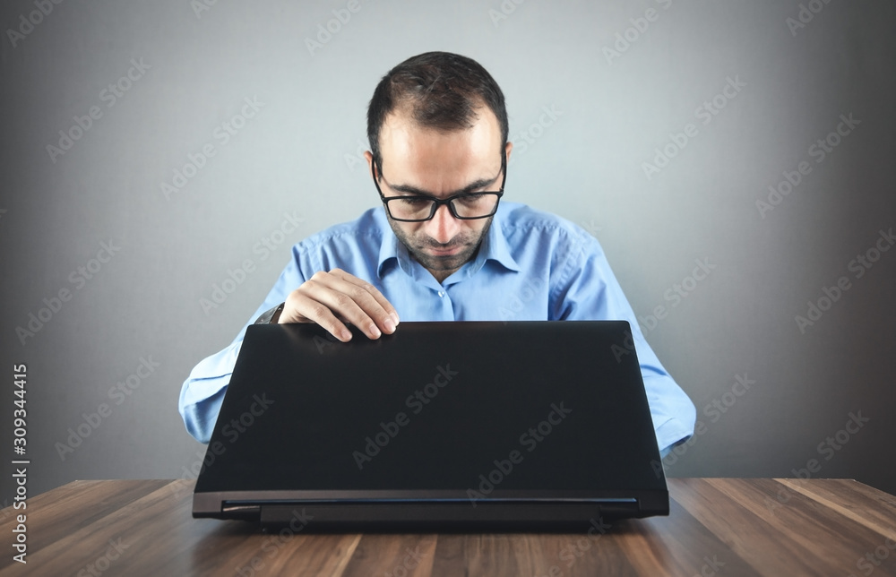 Businessman opening laptop on the table. Work Businessman opening laptop on the table. Work