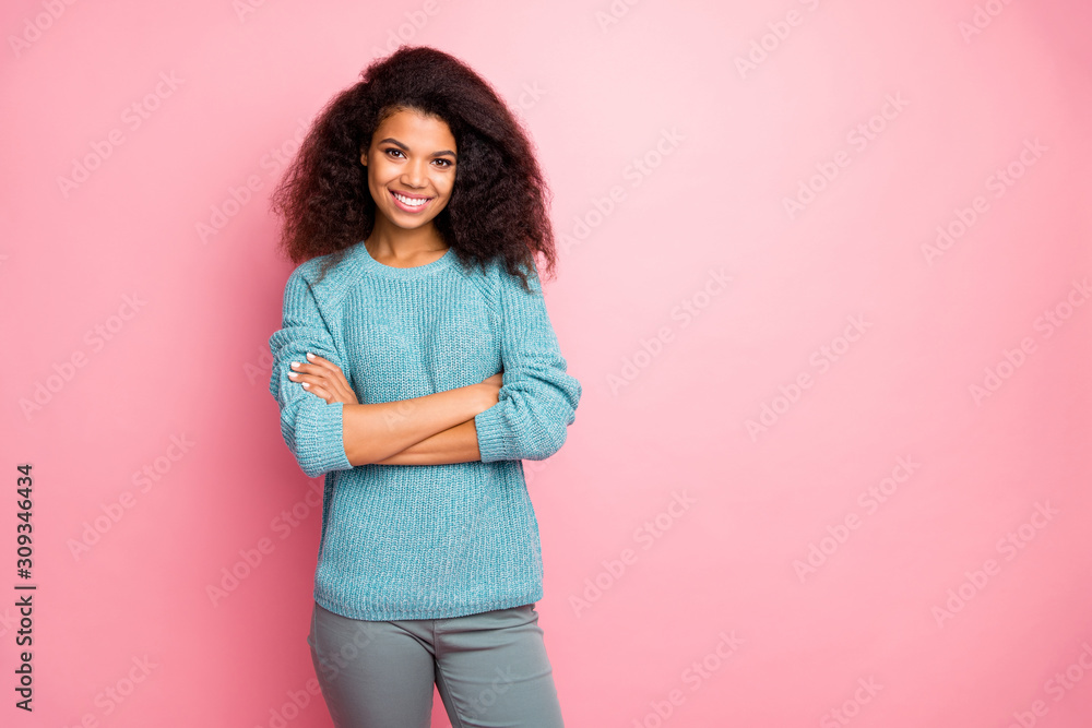 Photo of reliable intelligent woman with arms crossed in grey pants standing near empty space smiling toothily isolated pastel color background Photo of reliable intelligent woman with arms crossed in grey pants standing near empty space smiling toothily isolated pastel color background