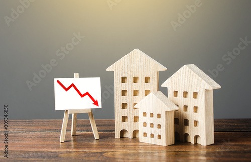 Canvas Print Wooden houses residential buildings and an easel with a red down arrow