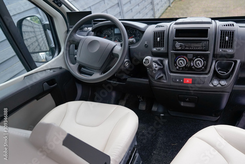 Luxury car van interior details black dashboard steering wheel © OceanProd